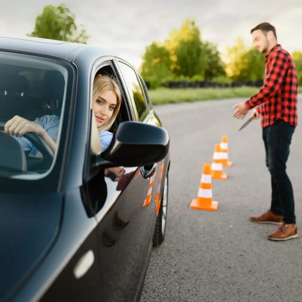 New student driver navigating a practice course with a driving instructor guiding from outside the vehicle during beginner driving lessons in Halifax NS