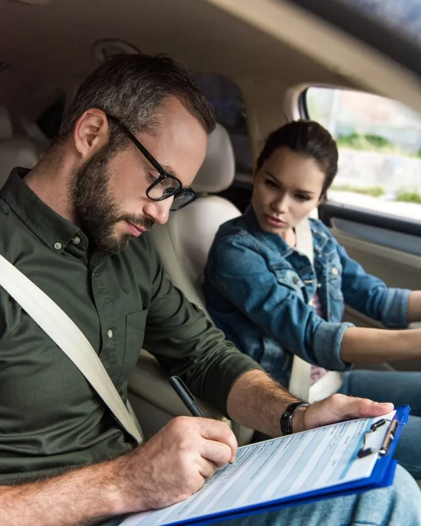Driving instructor reviewing evaluation notes with a student during a beginner driving lesson with Canadian Way Driver Training in Halifax NS